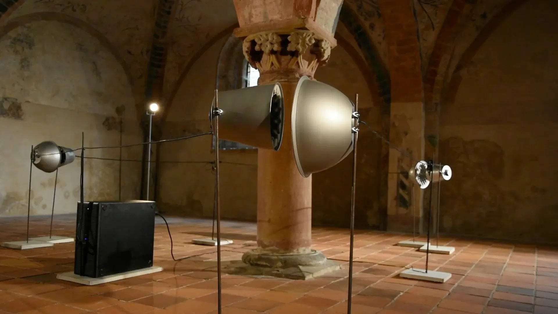 Four echo machines made of metal horns on thin tripods, connected by copper wire, in the choir of Brandenburg Cathedral